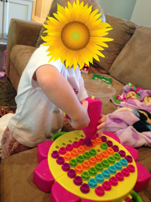 Two year old taking out the bits.