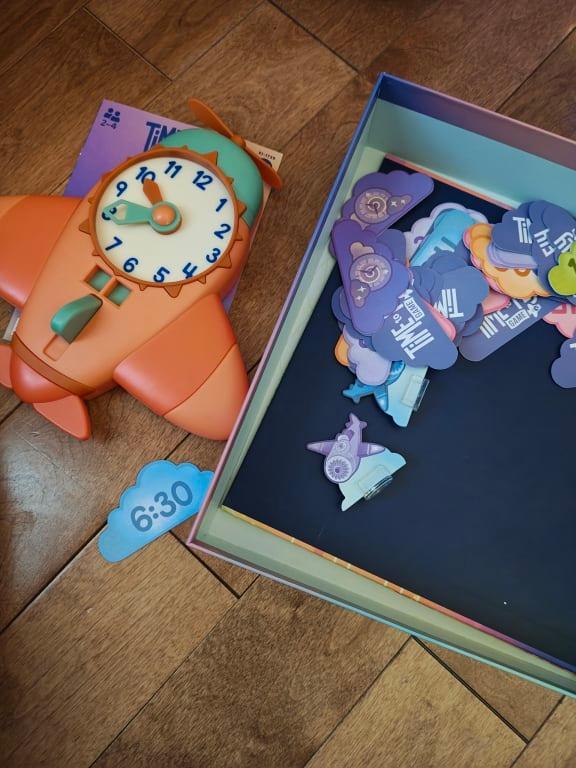 Clock to set time from card and check the answers. 4 game pieces and time cards