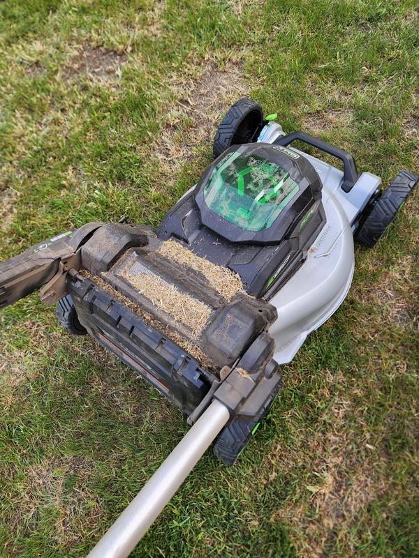 Grass blowing out of the bag