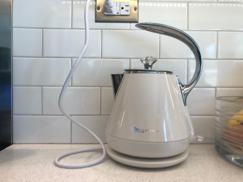 Kettle color against white subway tile backsplash.