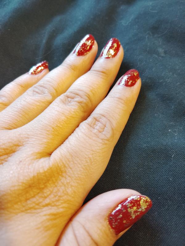 Essie's Summit of Style topcoat over dark red nail polish