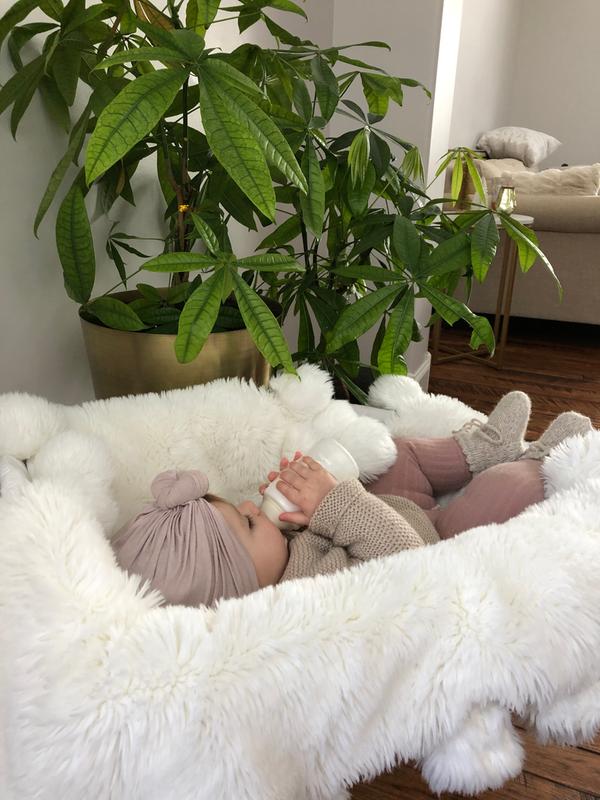 baby holding bottle