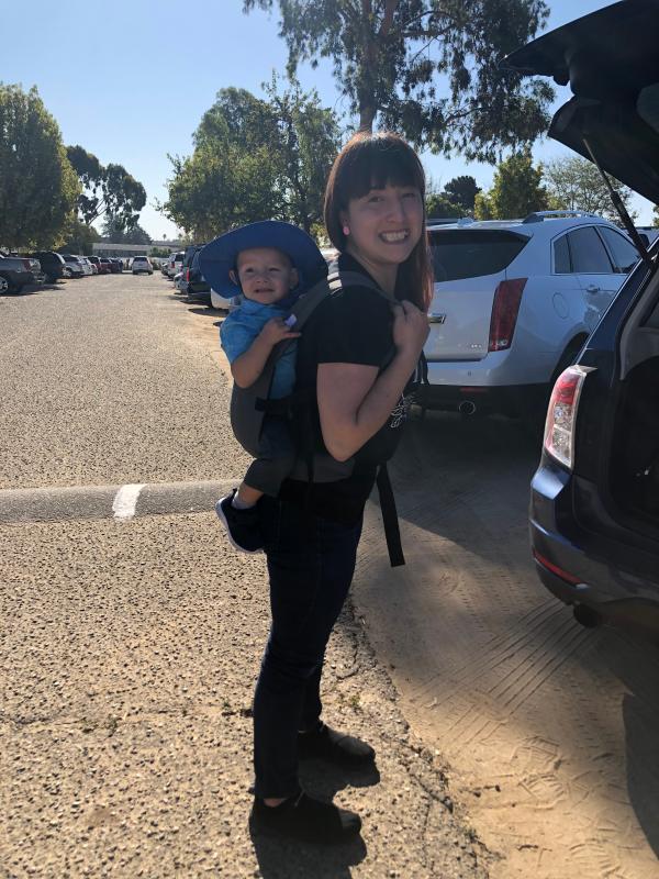 His arm is blocking a bit but the back cover ends just by his elbow in the photo.