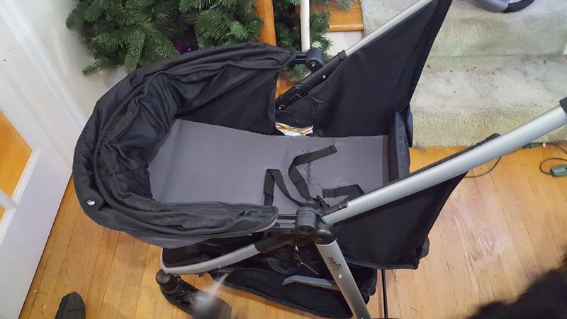 Carriage-mode with the footrest up. It can also be down to allow larger children to lay or be a changing table.