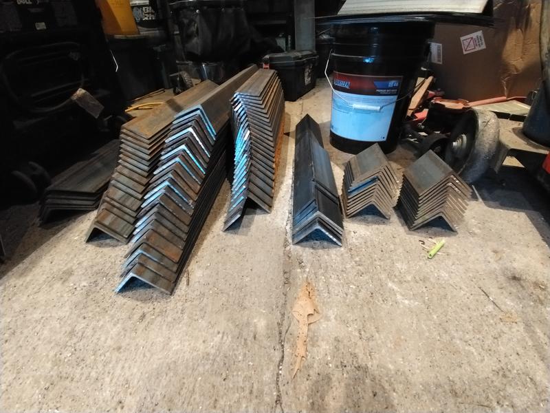 Stacks of 3/16" x 3" steel angle cut with a single blade...and the blade is still cutting!!