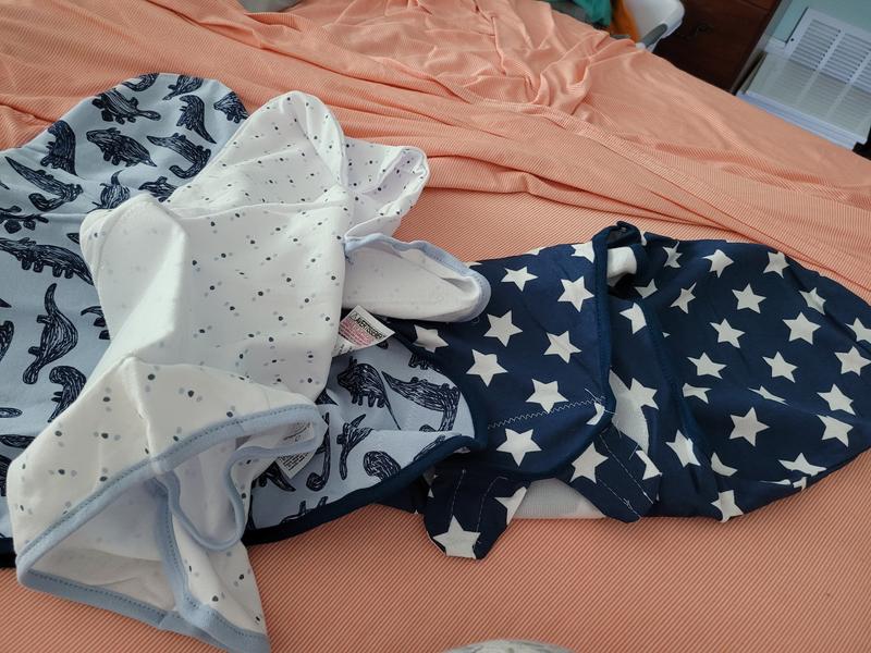 Swaddles laying on bed
