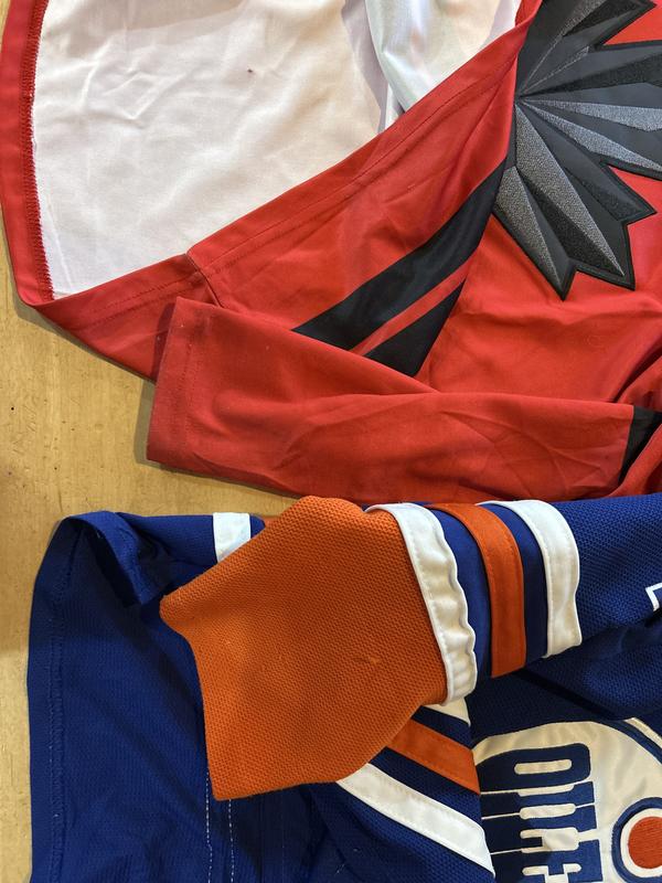 Comparing jersey material quality. The Olympic one is soft and thin compared to a typical hockey jersey.