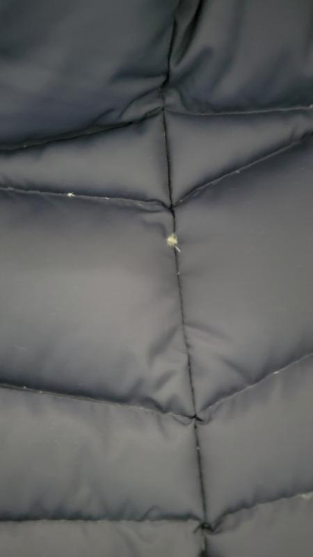 Photo is from after the repairs. Feathers popping out of seams