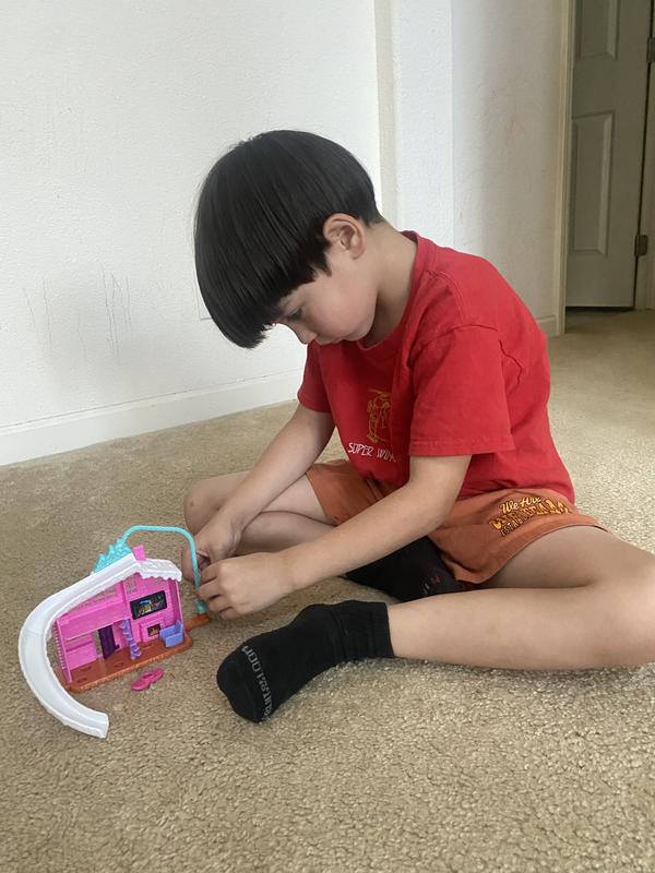 doll enjoying the twist apparatus of the side of the house