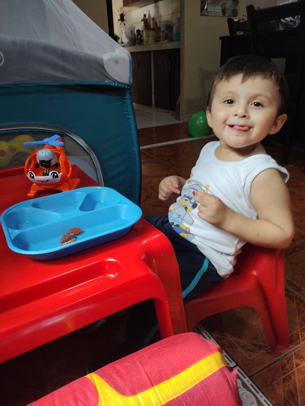 He is always playing with helicopter. Even when is having lunch.