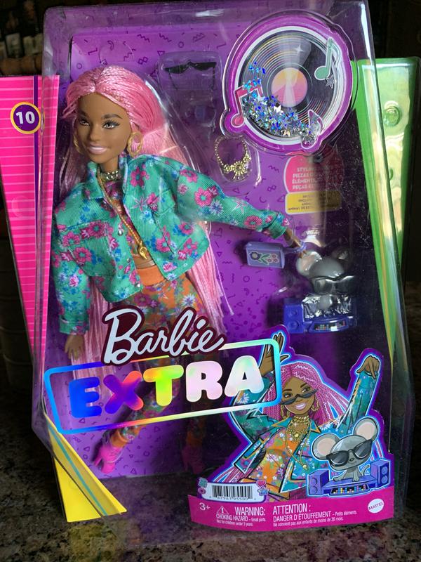 Barbie in her box with noted sparkly moving stars sticker we used for Barbie house decor