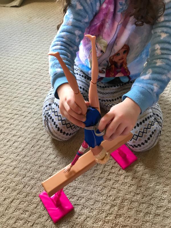 Barbie doing flips on the balance beam