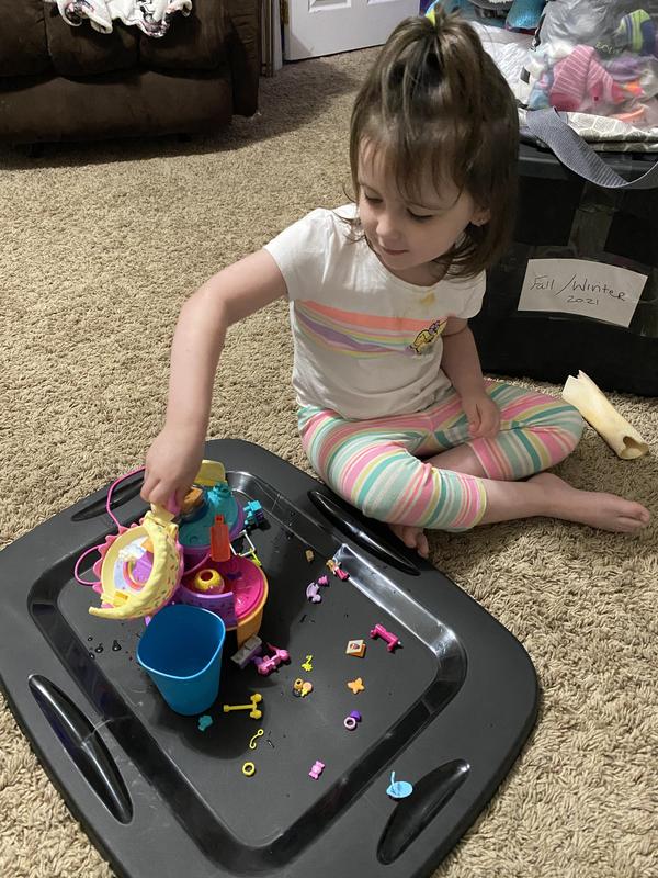 Playing with her Polly Pocket toy
