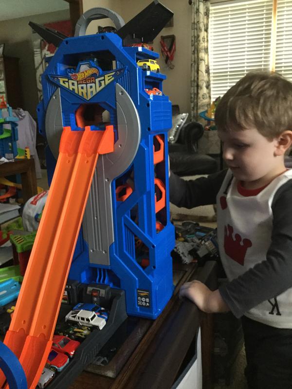 Playing with his Hot Wheels City Garage!