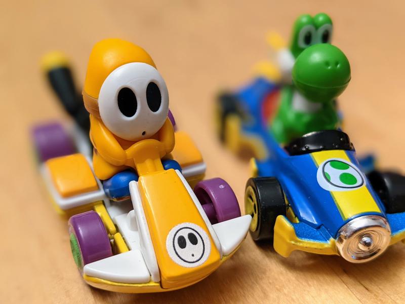 Orange Shy Guy & Yoshi in their karts