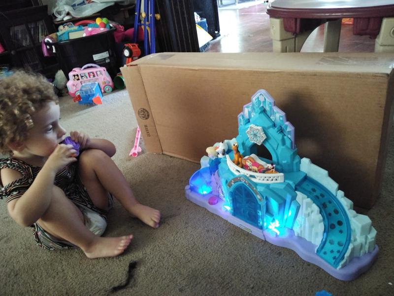 Putting her other figurines with Olaf and Elsa on the castle.