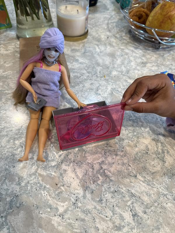 Barbie searching in the box of accessories