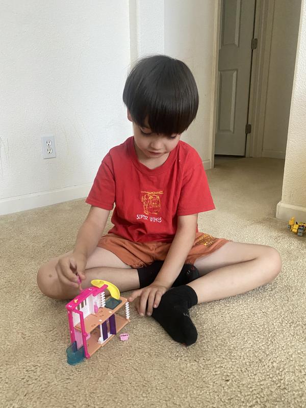 barbie walking on the raven behind the vacation home and toward the slide