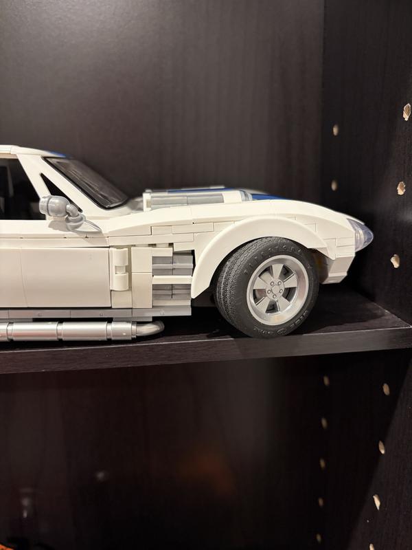 Tire pushing up on fender separating bricks to the left of the wheel well.