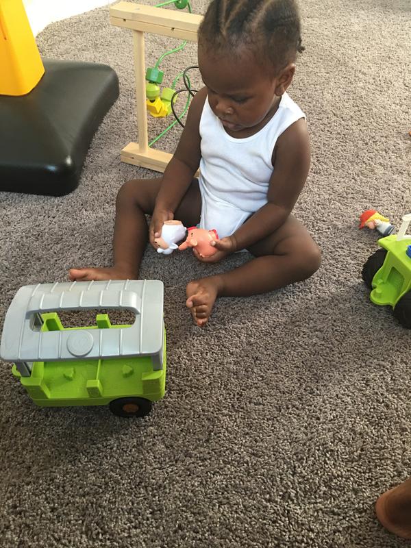 My 1 y/o playing with the tractor toy