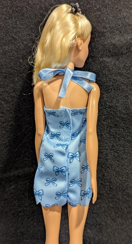 Cute dress with graphic print bows throughout, Velcro closure & ties at the neck with blue ribbon.