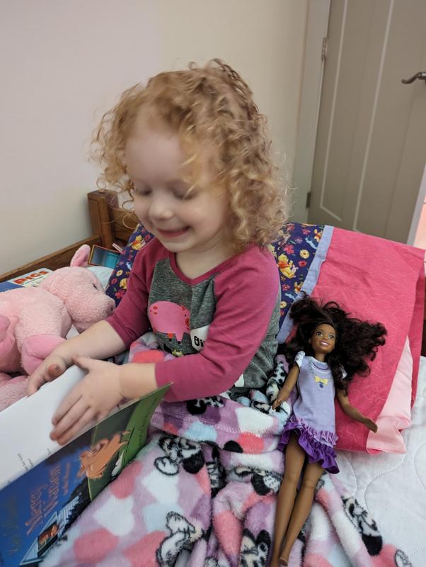 Treating her My First Barbie like a baby doll.