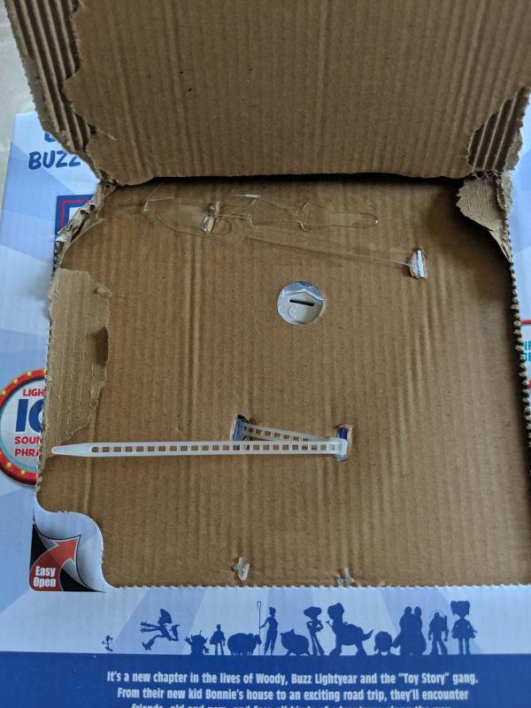 Back once opened, scissors needed to remove toy