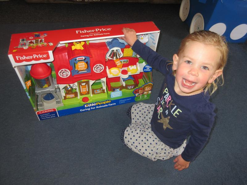 Little lady is very excited to 'open', 'open', 'open' the Caring for Animals Farm!