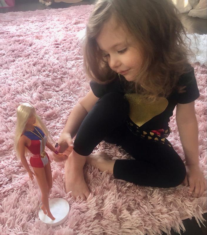Having fun playing with her Barbie doll! Her smile tells it all!