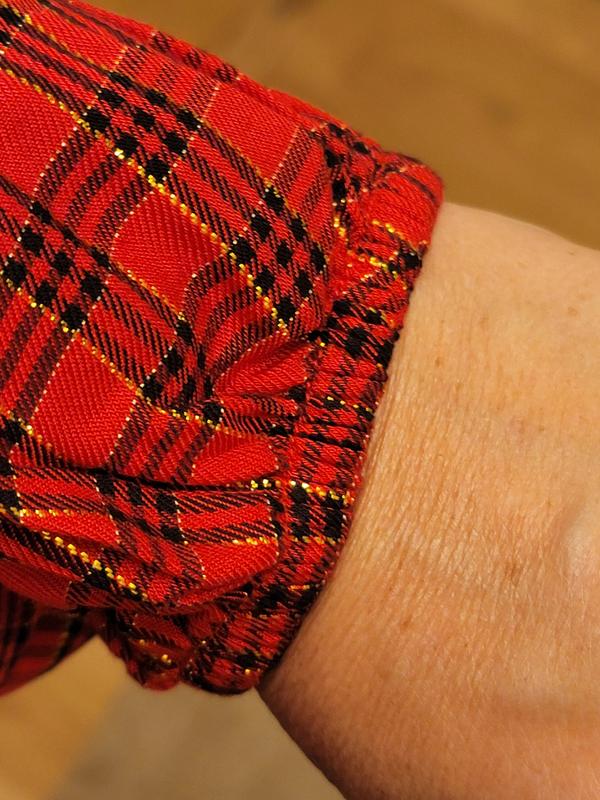 Bright gold stitching, elastic arm cuff