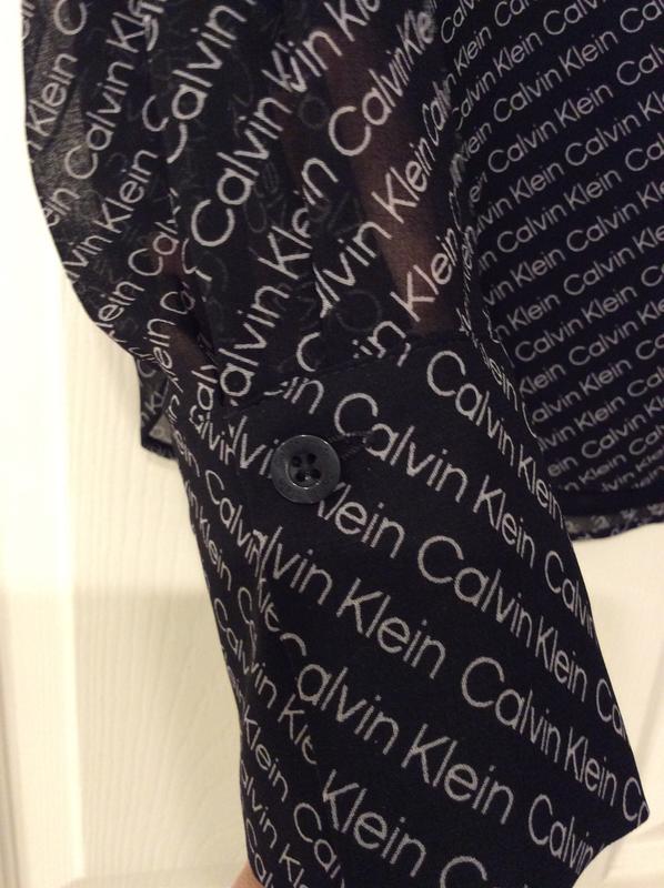 Sheer long sleeve, solid cuff with black button detail