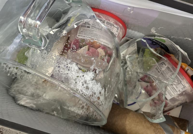 Broken glass bowl in garbage can