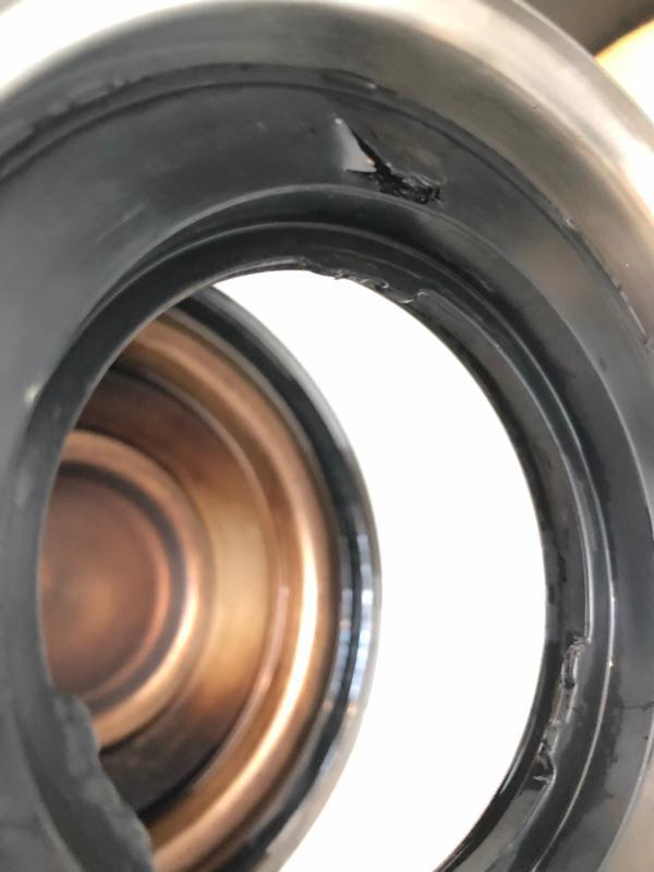 Cracked and raised plastic lip, preventing airtight seal.