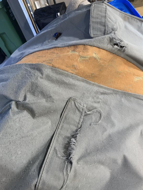 Front of cover with seams torn.