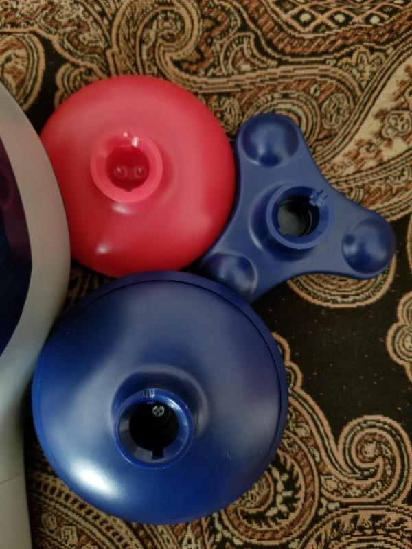 The three hard plastic attachments. Red stays in place, but both blues fall off.