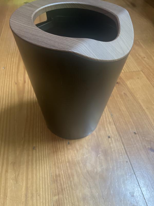 Trash can as sitting on floor.