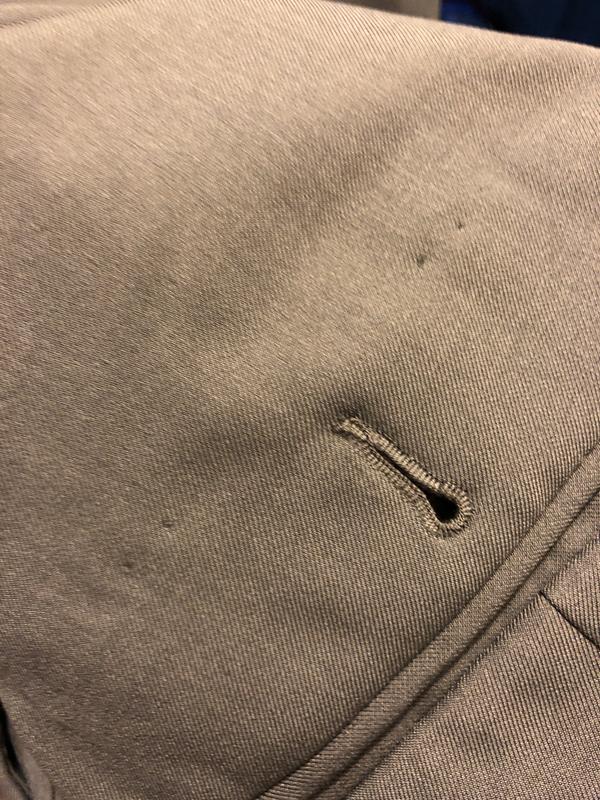 Holes left where (excessive) advertising tags were recklessly attached to back pockets!