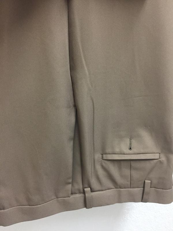 Creases on back of pants near front pocket that starts at waistband  that goes down the leg along the side seam.