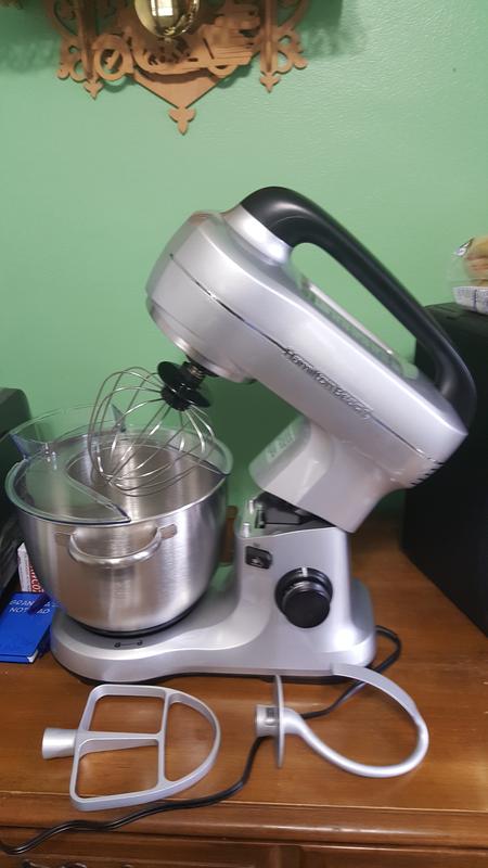 Mixer showing attachments & how it tilts, also shows splash guard
