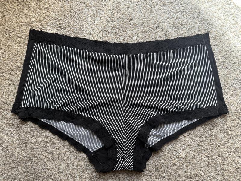 A new pair piled on top of an older pair. You can clearly see how the pair on the bottom is larger (the black sticking out under the stripes)