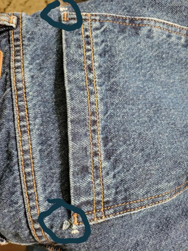 Ripped at both sides of the back pocket