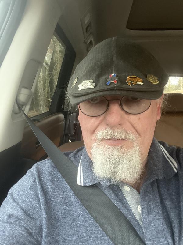 Carl B wearing one of the  many Harley Davidson caps in his collection.