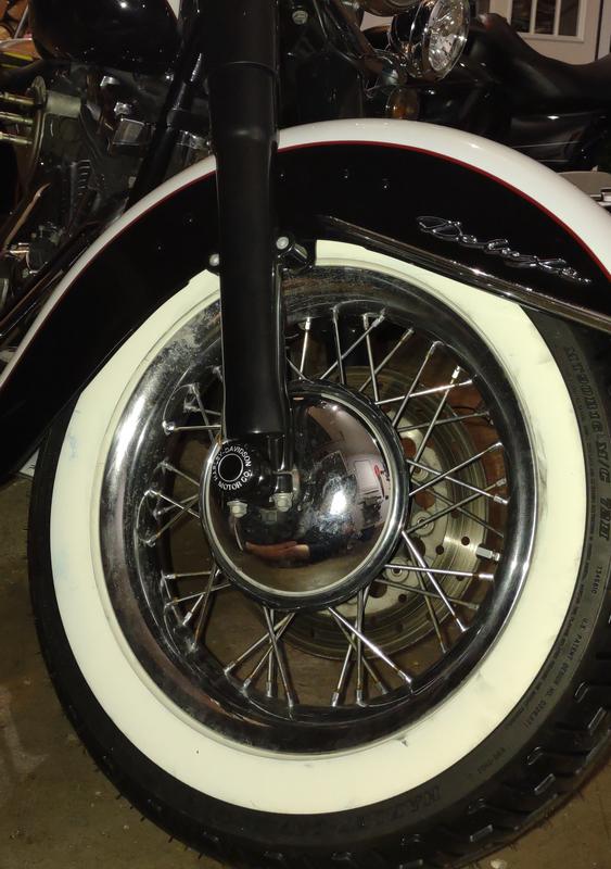Harley Motor Co. front axle nut covers on custom Softail Deluxe front forks