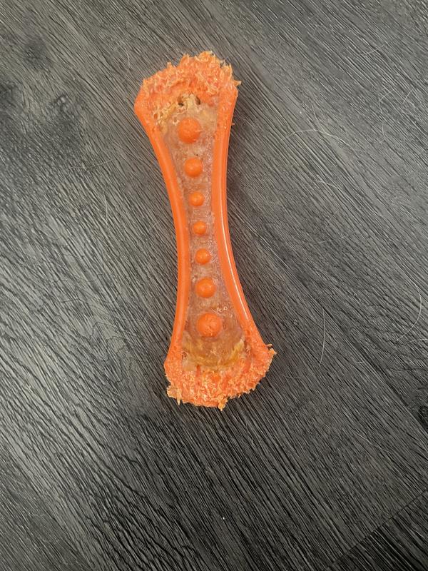 Orange dog toy near chewed up near the end.