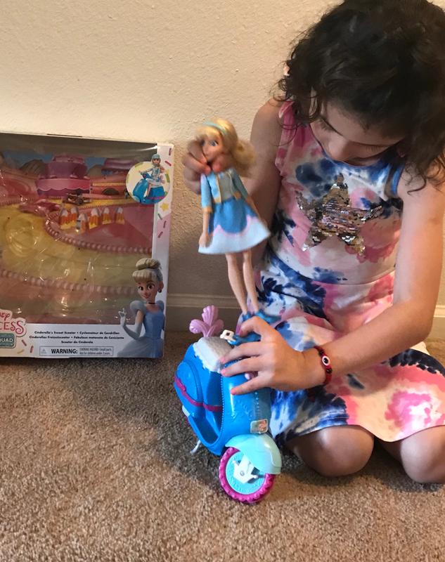 Cinderella sits on scooter by herself.