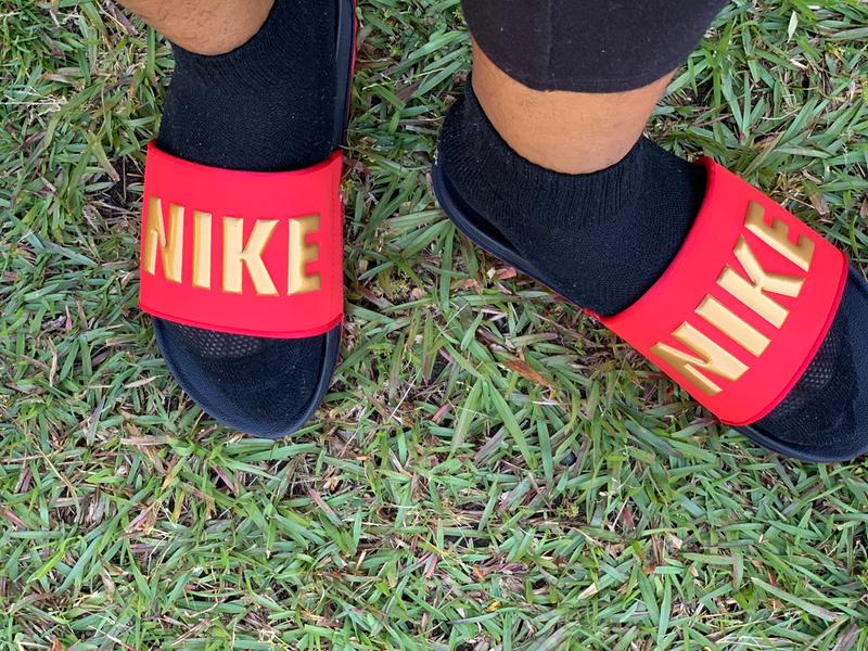 red nike sandals with gold check