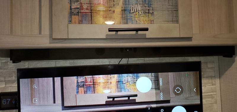 The Bar literally wedged up underneath nice and tight. With a little double-sided tape, it is secured