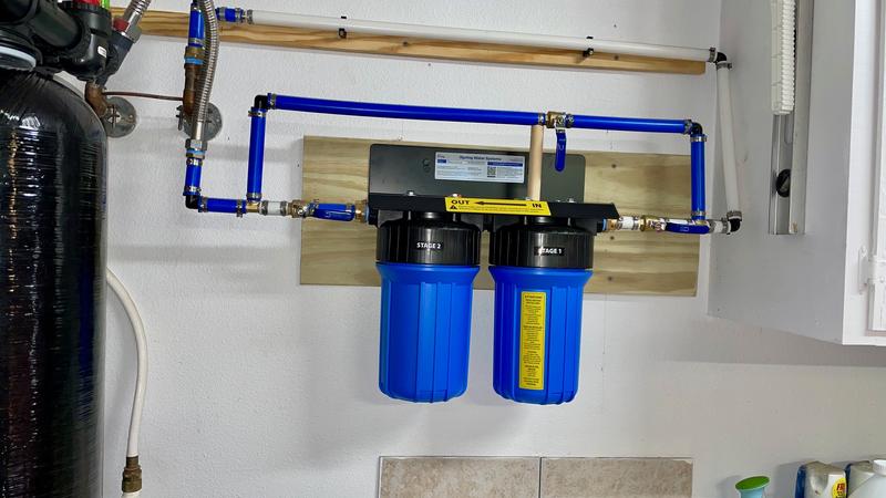 Mounted on wall over laundry tub next to softener