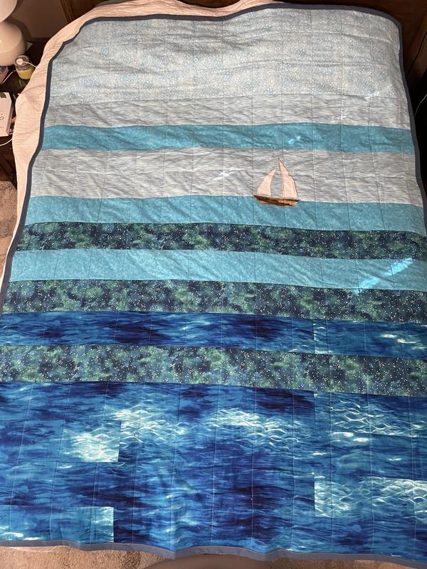 Twin size quilt aproximately 68 x 72 inches 100% cotton fabrics, cotton  batting, machine pieced and quilted.