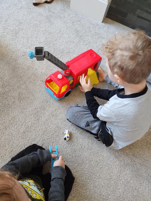 Teaching little brother how to play with his firetruck